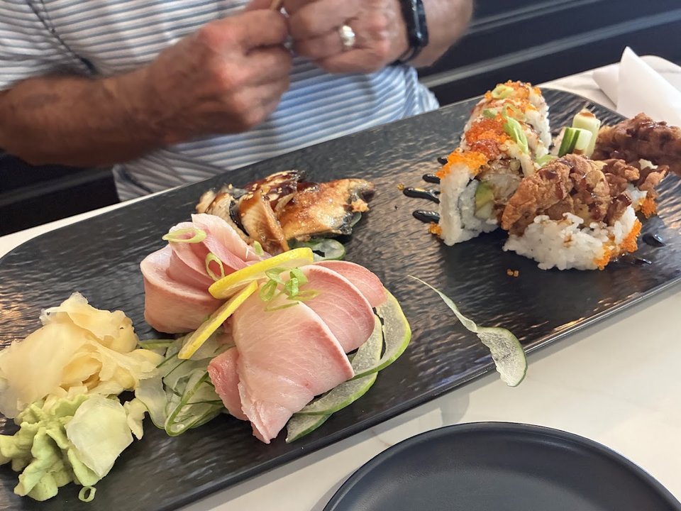 Sushi rolls arranged on a clean restaurant table.